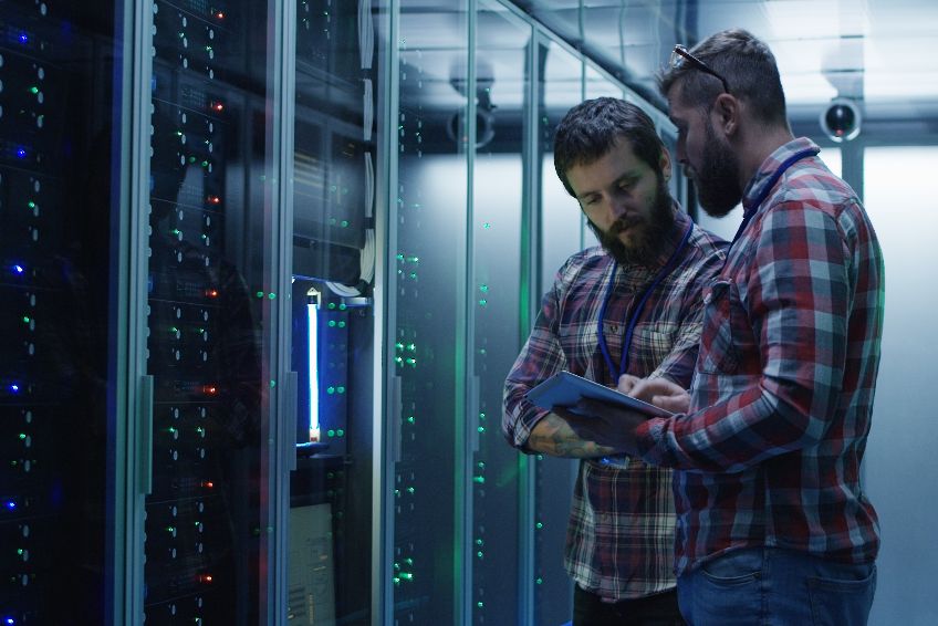 Coworking adult men diagnosing server hardware
