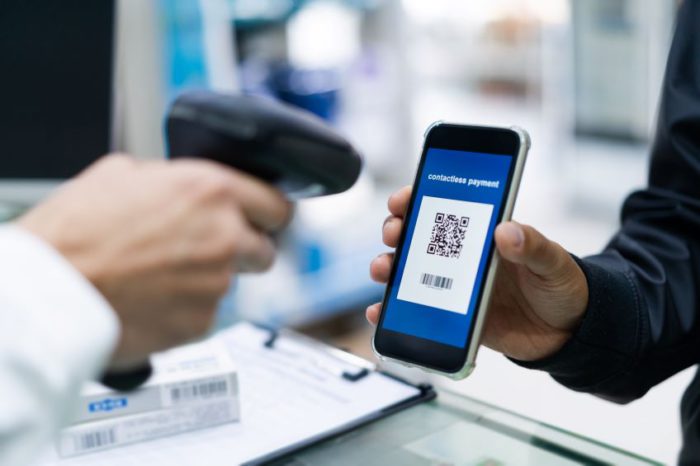 Image of a retailer scanning a QR code from a mobile phone.