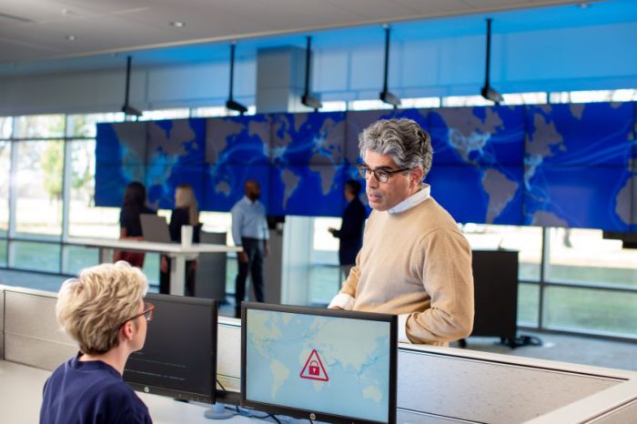 Two people talking in a Global Operations Center.