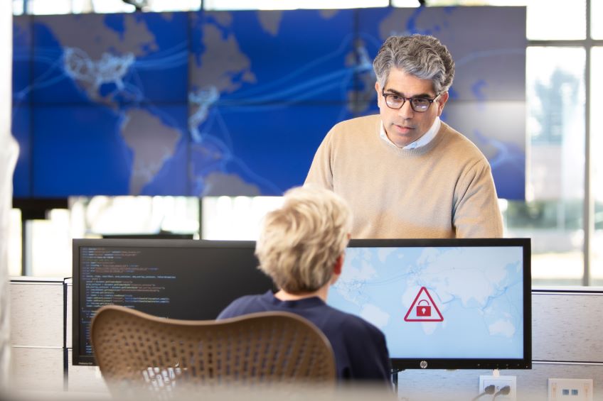 Two people talking in a Global Operations Center.