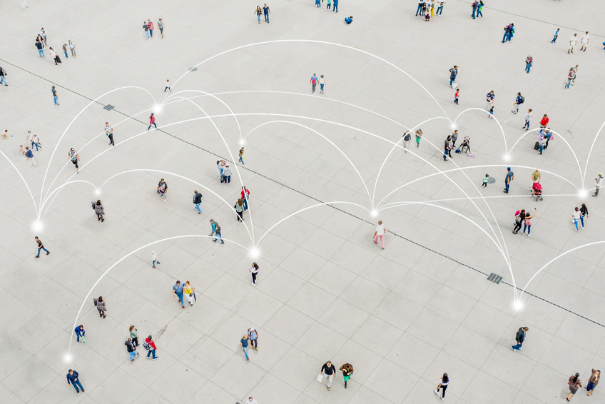 Overhead image of people walking in a plaza with network lines connecting them.