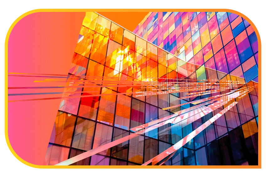 Colorful glass facade of a modern building with geometric patterns and reflections.